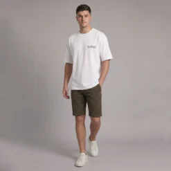 Man wearing a white t-shirt with YOLO REPUBLIC printed on the chest, olive green shorts, and white sneakers